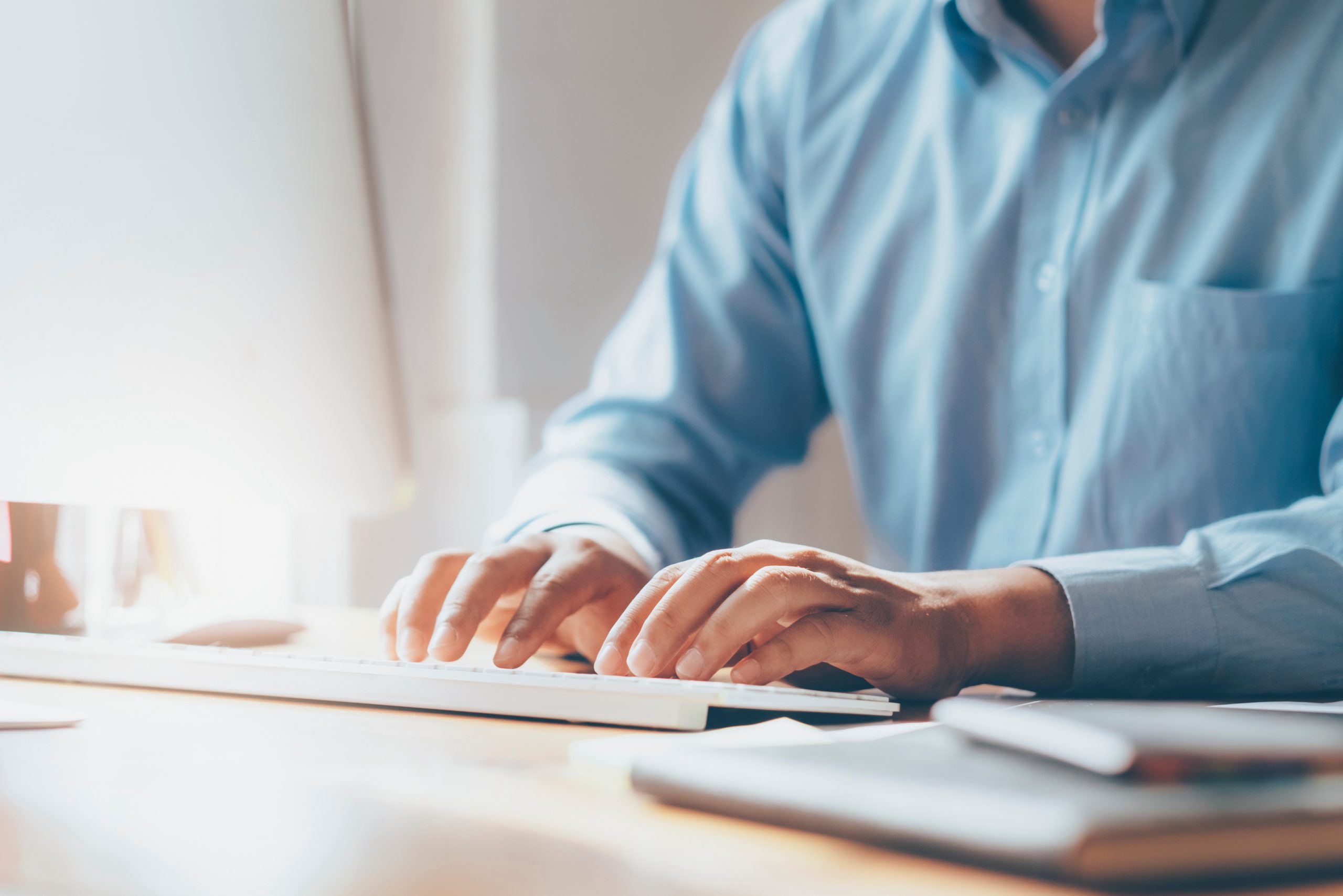 man using computer and typing on keyboard